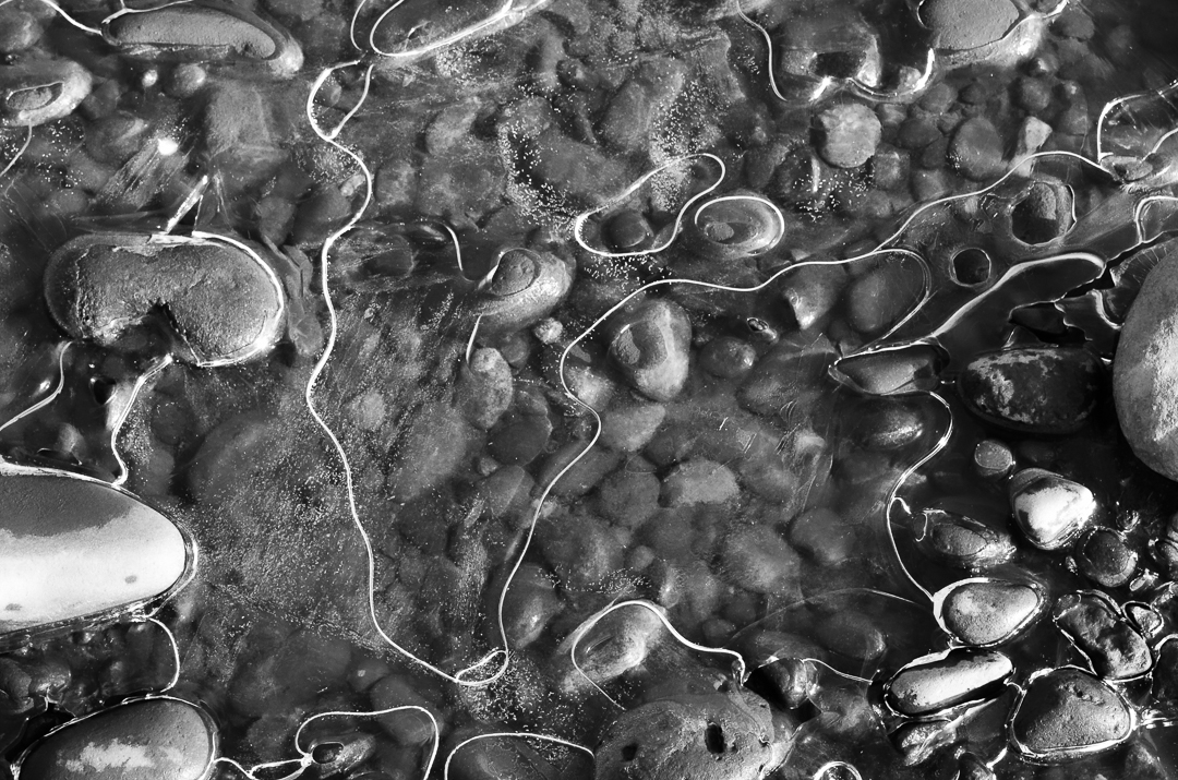 a monochdrome image of ice and rocks.